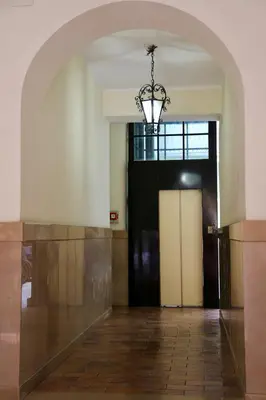 an empty hallway with a door and a chandelier at Borgo Vittorio St. Peter Apartments in Rome