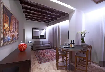 a living room with a table and a couch at Harry's Bar Trevi Luxury Apartments - Modelli in Rome