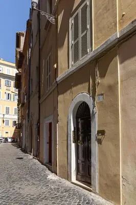 an alley with an archway on a building on a street at Harry's Bar Trevi Luxury Apartments - Modelli in Rome