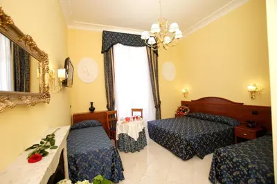 a hotel room with two beds and a mirror at Caroline Suite in Rome