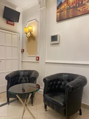 two leather chairs and a glass table in a room at Hotel Erdarelli in Rome