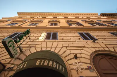 a building with a sign on the side of it at Hotel Giorgina in Rome