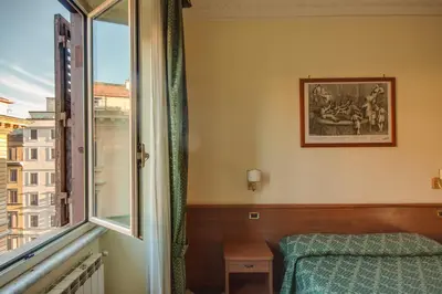 a bedroom with a bed and a window at Hotel Giorgina in Rome
