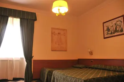 a bedroom with a bed and a window at Hotel Giorgina in Rome
