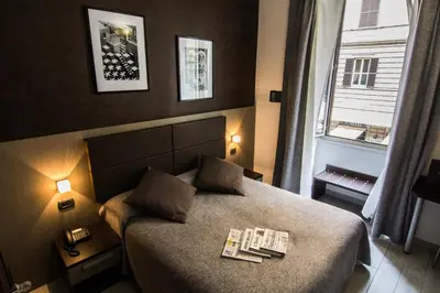 a hotel room with a bed and a window at Hotel Charter in Rome