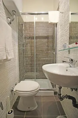 a bathroom with a toilet and a sink at Hotel Charter in Rome
