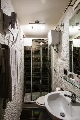 a bathroom with a toilet and a sink and a shower at Hotel Charter in Rome