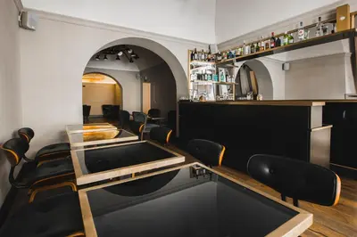 a bar with black chairs and a table in a room at Relais 88 in Rome