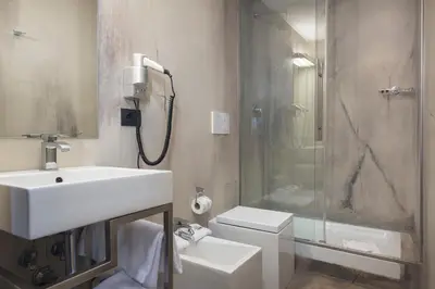a bathroom with a sink and a shower and a toilet at Relais 88 in Rome