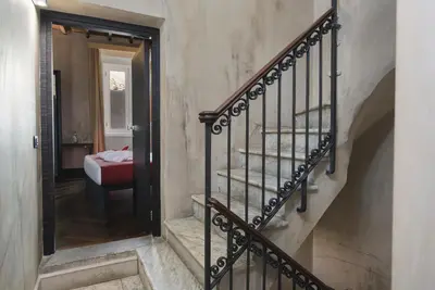 a stairway with a mirror in a hallway at Relais 88 in Rome