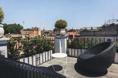 a patio with two chairs and a table on a balcony at Relais 88 in Rome