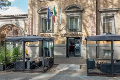 a building with two umbrellas in front of it at Hotel Metropolis in Rome