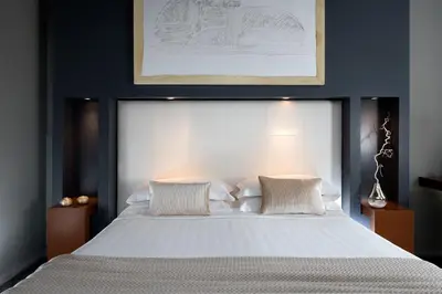 a bedroom with a large white bed with two pillows at Hotel Metropolis in Rome