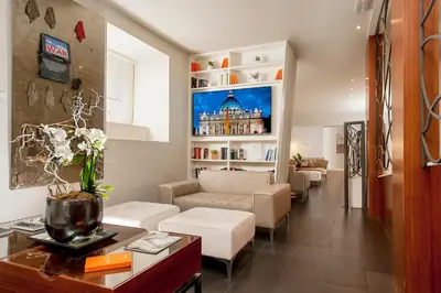 a living room with a couch and a table at Hotel Metropolis in Rome