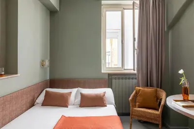a hotel room with a bed and a window at Hotel Marisa in Rome
