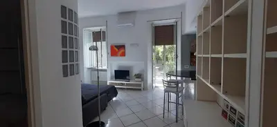 a room with a bed and a kitchen with a table at Trastevere St. Garden House in Rome