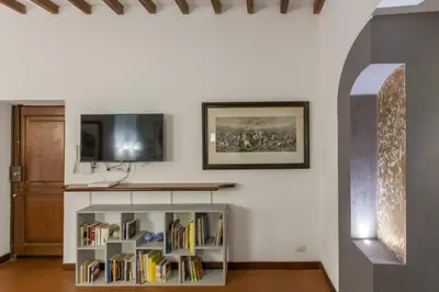 a living room with a book shelf with books at Navona apartment in Rome