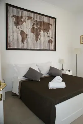 a bedroom with a bed with a map on the wall at St.Peter Accomodation in Rome