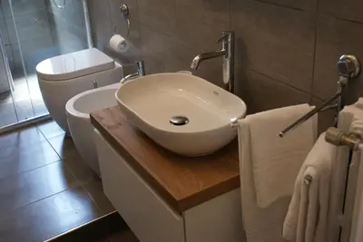 a bathroom with a white sink and a toilet at St.Peter Accomodation in Rome