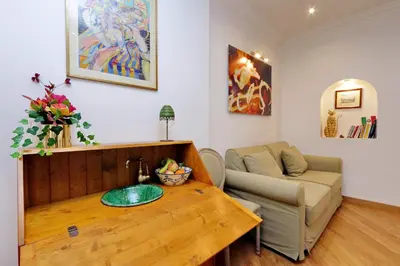 a living room with a table and a couch at Sistina in Rome