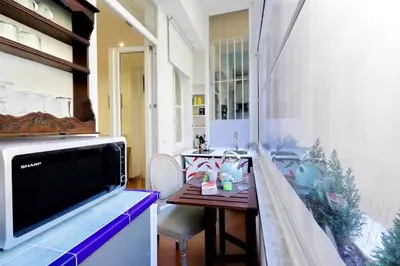 a kitchen with a table and a tv in a room at Sistina in Rome