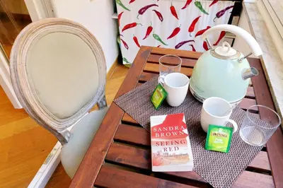 a table with a tea kettle and a book on it at Sistina in Rome
