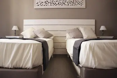 two beds sitting next to each other in a bedroom at rHome Sweet Home - Trastevere in Rome