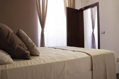 a bed in a room with a window and a door at rHome Sweet Home - Trastevere in Rome