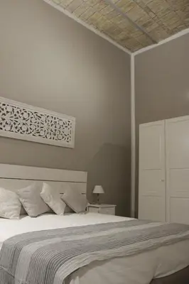 a bedroom with a large bed with a white bedspread at rHome Sweet Home - Trastevere in Rome
