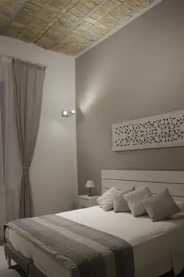 a bedroom with a large white bed with pillows at rHome Sweet Home - Trastevere in Rome
