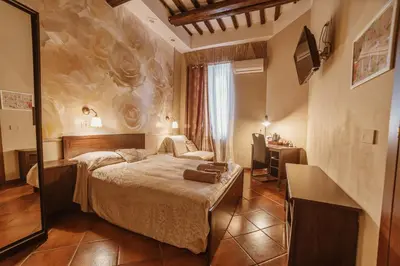 a hotel room with a bed and a desk at Ronda St. Angelo Suites in Rome