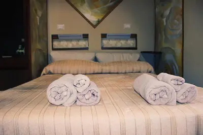 a bed with towels on top of it at Ronda St. Angelo Suites in Rome