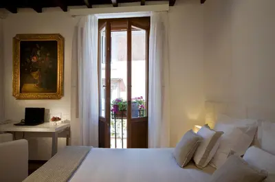 a bedroom with a bed and a sliding glass door at Gigli D'Oro Suite in Rome