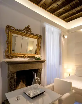 a living room with a fireplace and a mirror at Gigli D'Oro Suite in Rome