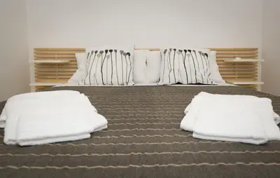 a bedroom with a bed with white pillows at Ottaviano Exclusive Maison in Rome