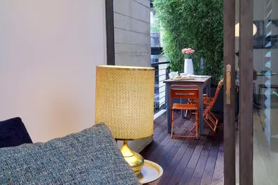 a yellow lamp sitting on a deck with a table at Rome Unique Monti Colosseum in Rome