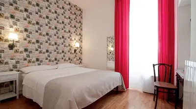 a bedroom with a bed and a brick wall at Domus Iuliae in Rome