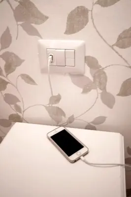 a cell phone hooked up to a light switch at Domus Iuliae in Rome