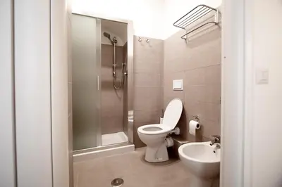 a bathroom with a toilet and a sink and a shower at Domus Iuliae in Rome