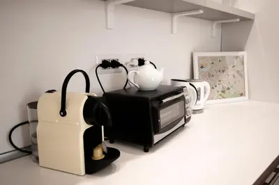 a room with a microwave and various appliances at Domus Iuliae in Rome