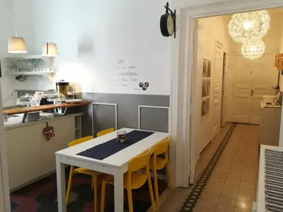 a kitchen with a white table and yellow chairs at MiRhome Guest House in Rome