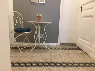a table with glasses and pictures on a wall at MiRhome Guest House in Rome