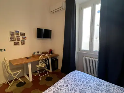 a bedroom with a bed with a lamp next to a window at MiRhome Guest House in Rome
