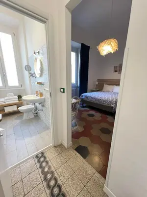 a hotel room with two beds and a mirror at MiRhome Guest House in Rome