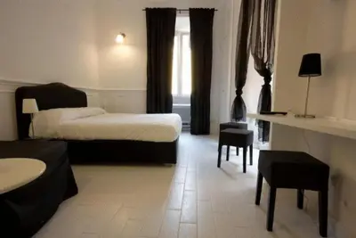 a hotel room with a bed and a living room at Intra' Residenza in Trastevere in Rome