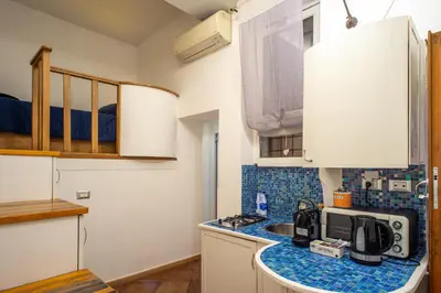 a kitchen with a sink and a counter top at Intra' Residenza in Trastevere in Rome
