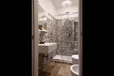 a bathroom with a shower and a sink and a toilet at Relais Barberini in Rome