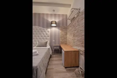 a room with a bed and a desk in it at Relais Barberini in Rome