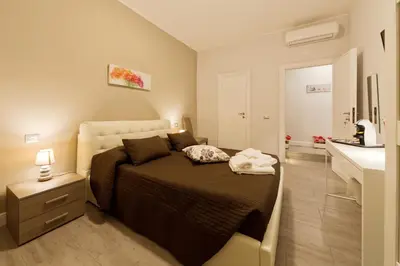 a bedroom with a large bed and a sink at Pianeta roma 48 in Rome