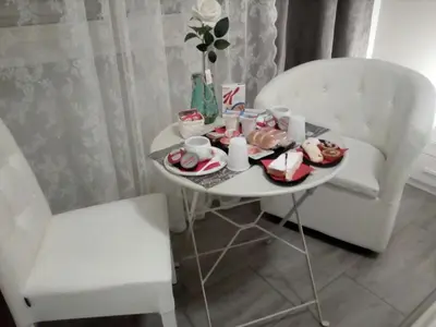 a table with a plate of food and a chair at Pianeta roma 48 in Rome